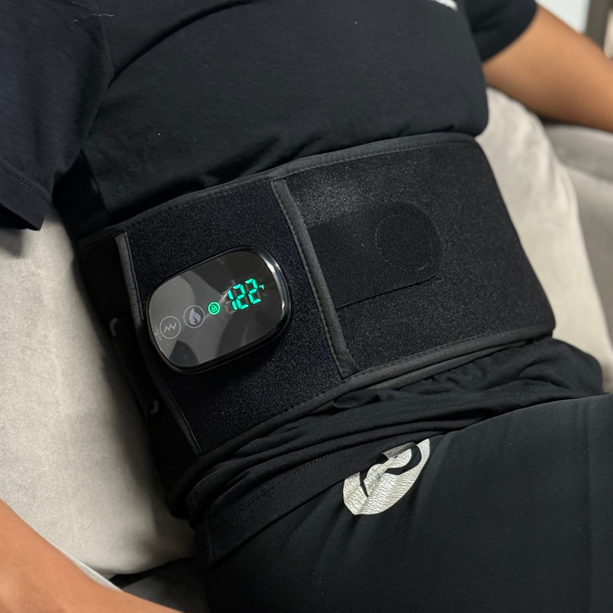 TheraBelt controller worn at the waist with the temperature display lit