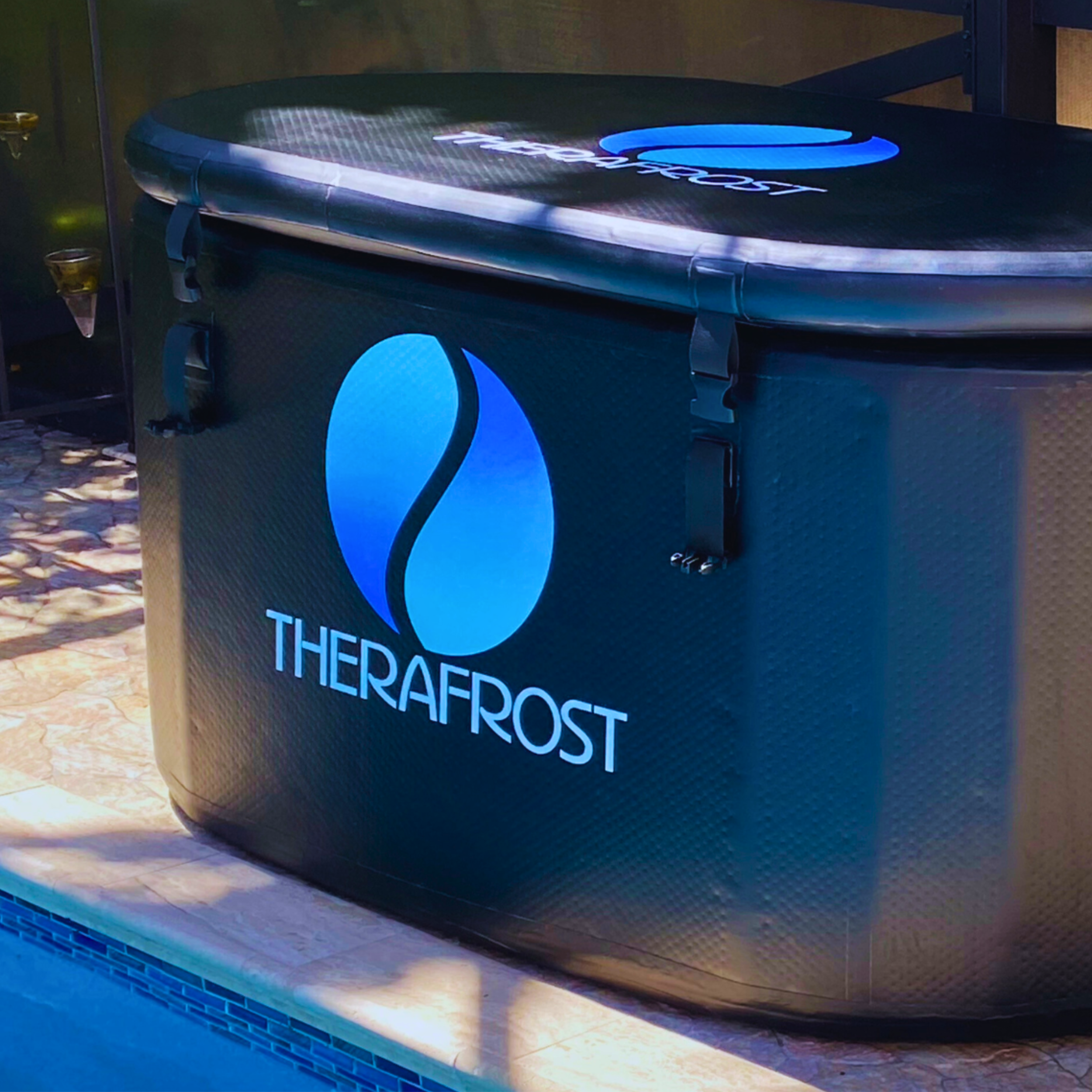 TheraFrost Cold Plunge with insulated lid strapped on, set up poolside