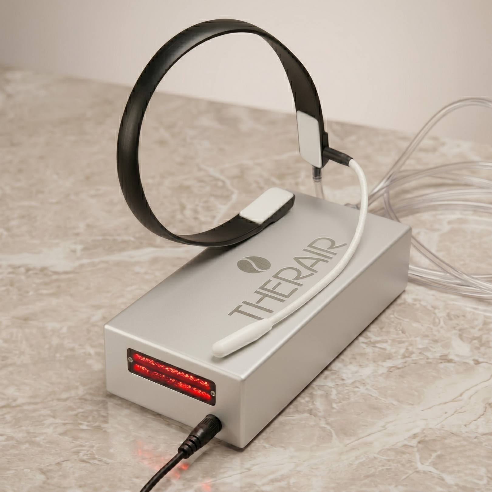 TherAir Plus on a table with its cannula and headband accessory