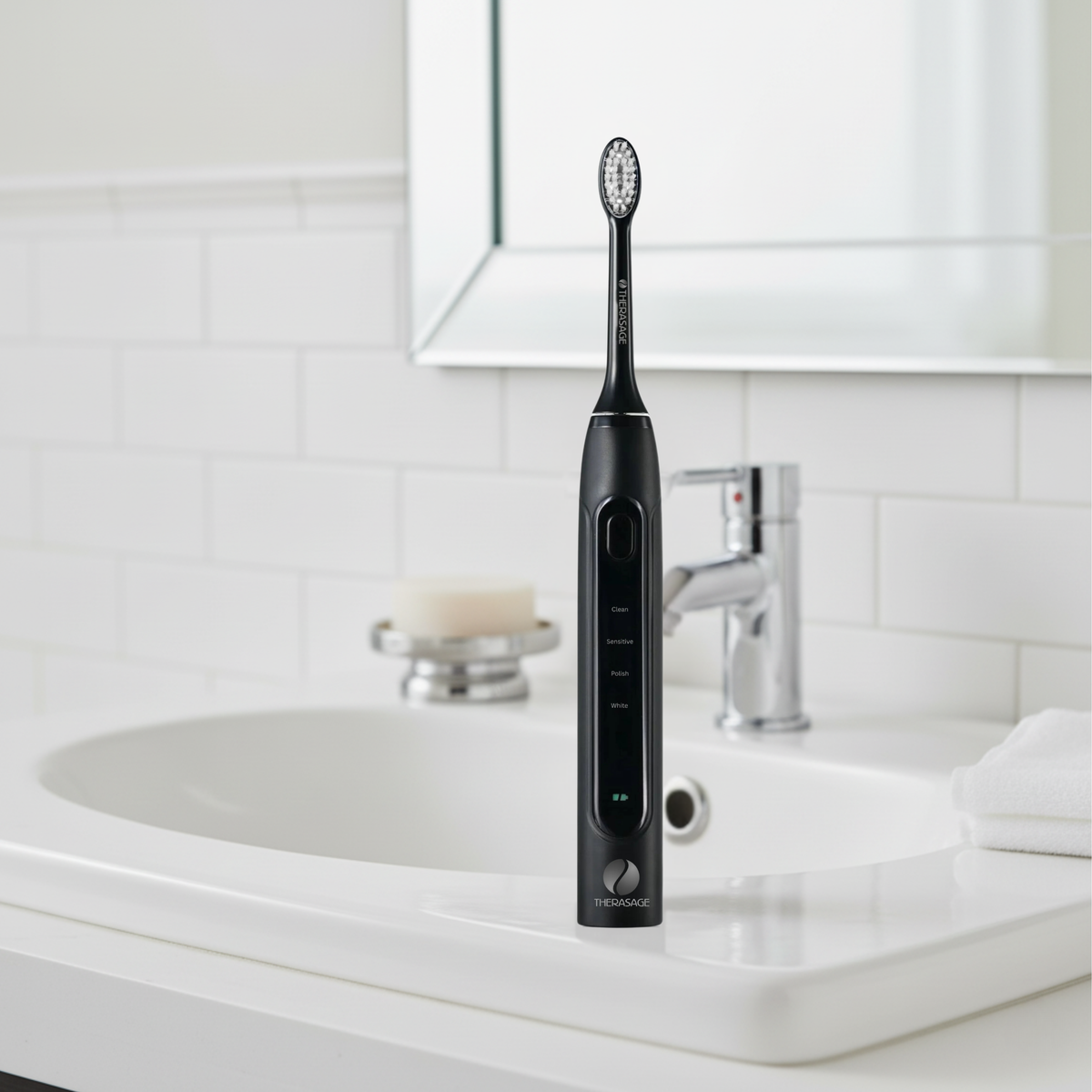 Black TheraSmile toothbrush standing on a bathroom sink