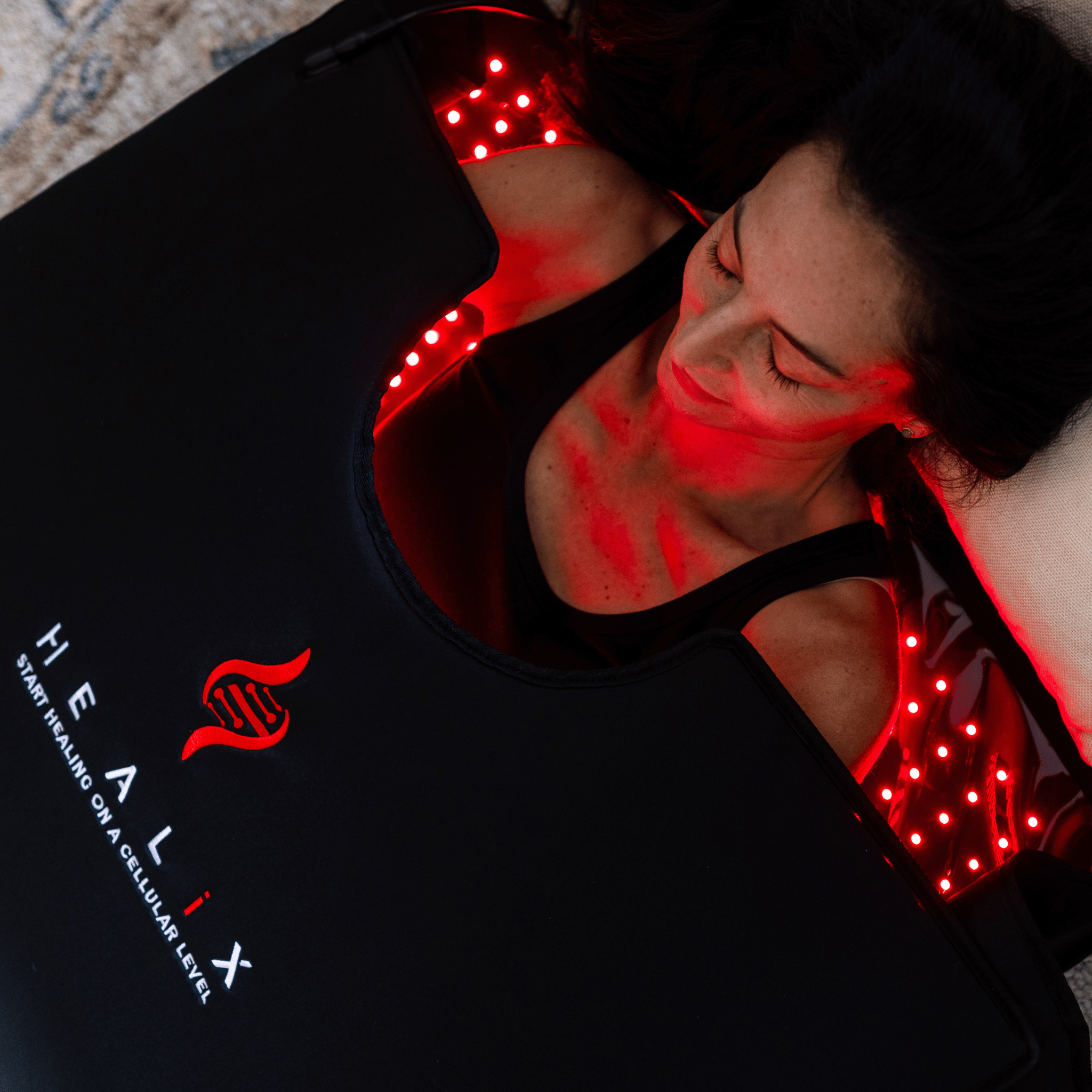 HEALiX Elevate Light Pod red light therapy on the face and shoulders