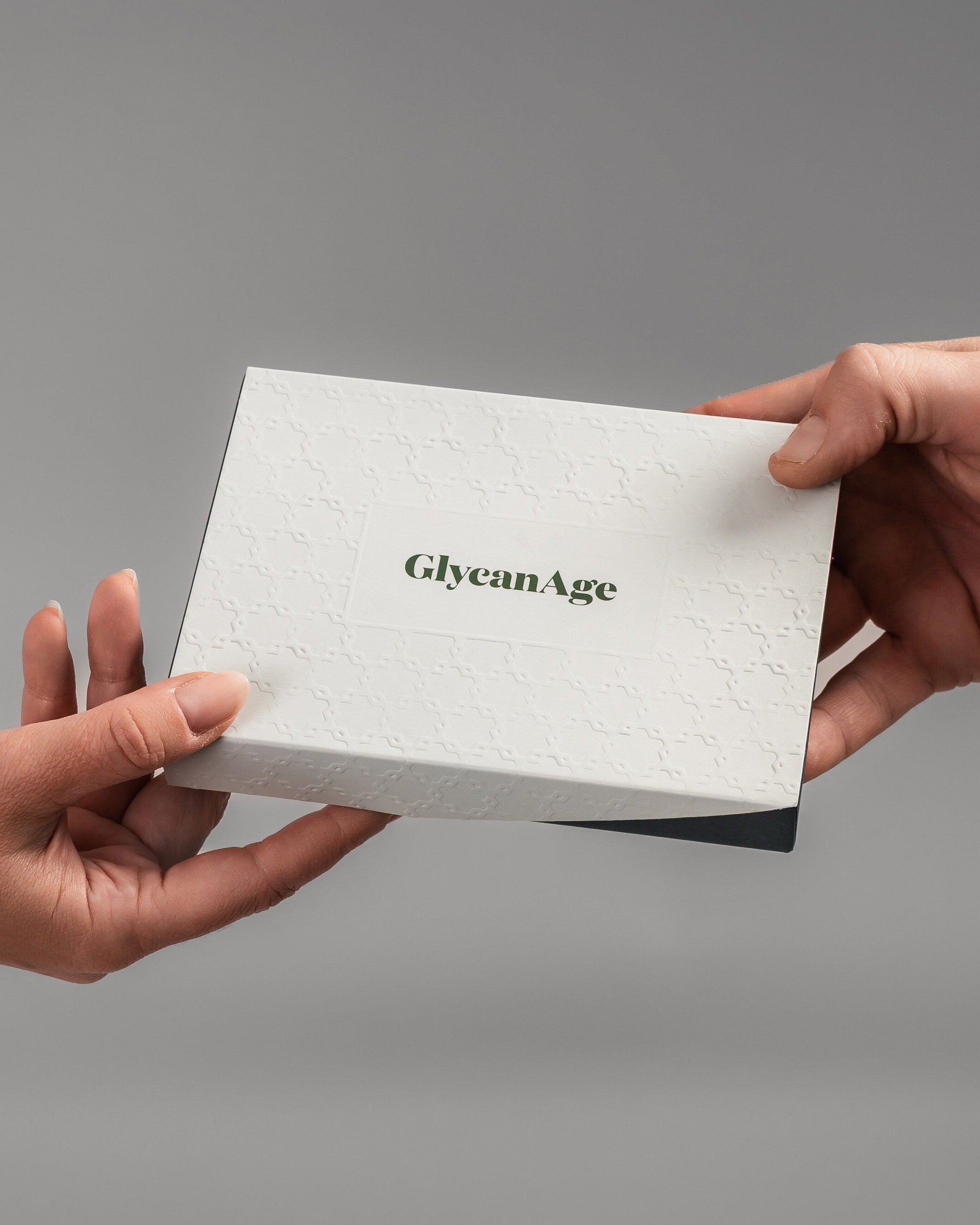 GlycanAge test kit being handed from one person to another