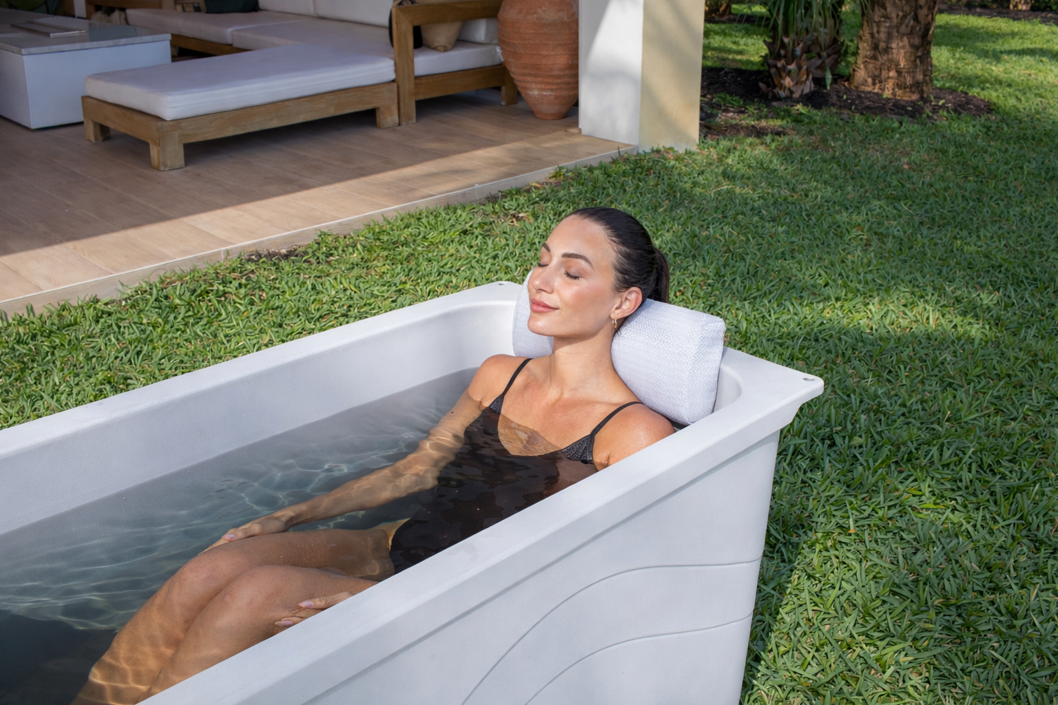 Frozin 400 white granite cold plunge, woman resting on the headrest pillow #Color_White Granite