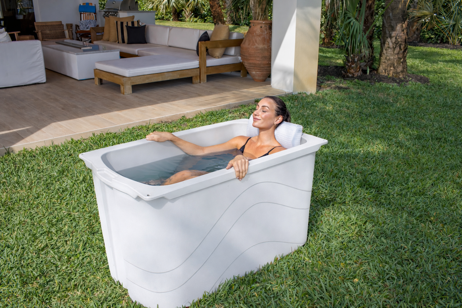 Frozin 400 white granite cold plunge with a woman relaxing on the lawn #Color_White Granite
