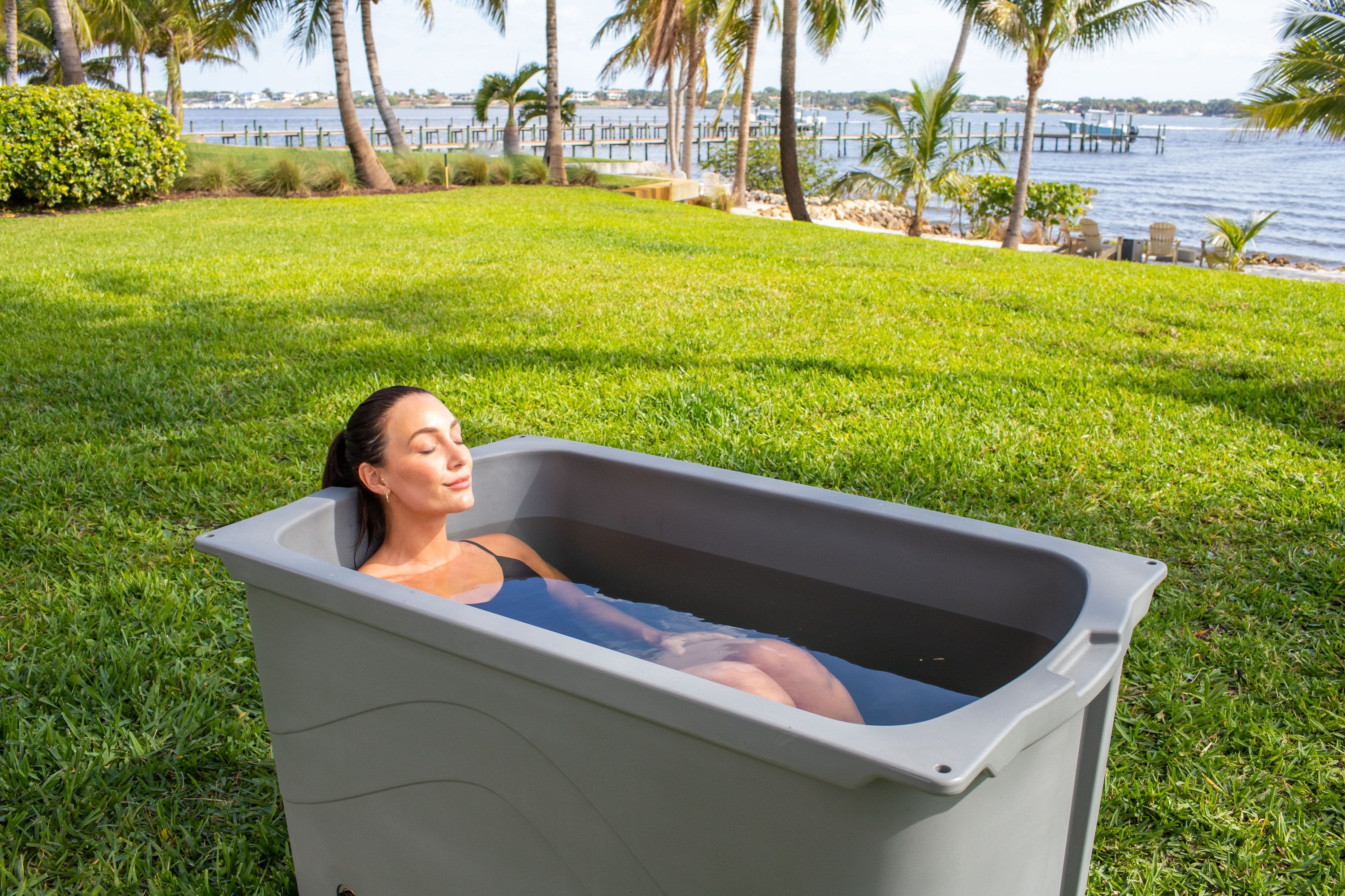 Cold plunge tub on a waterfront lawn