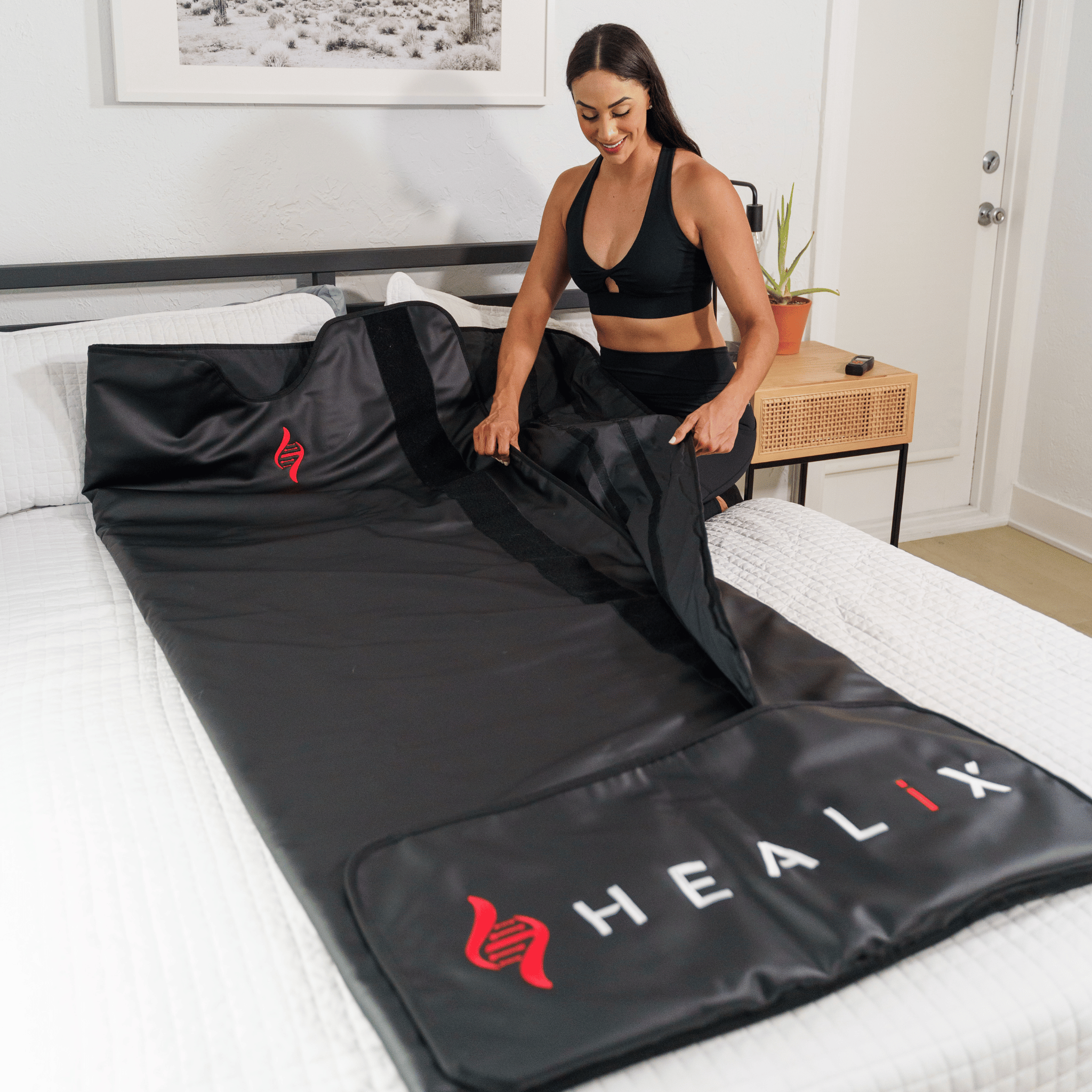 Getting into the HEALiX infrared sauna blanket on the bed