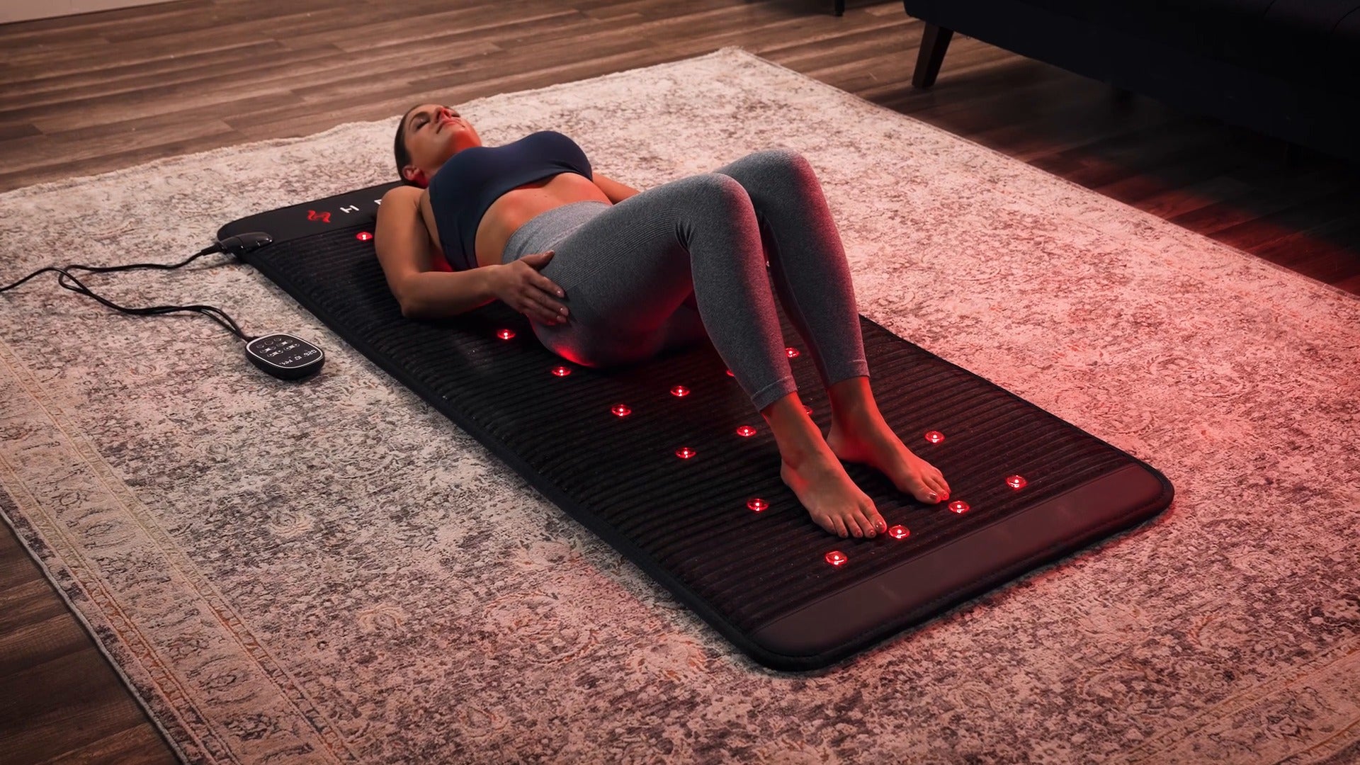 Reclining on the HEALiX Revive PEMF mat with the lights on