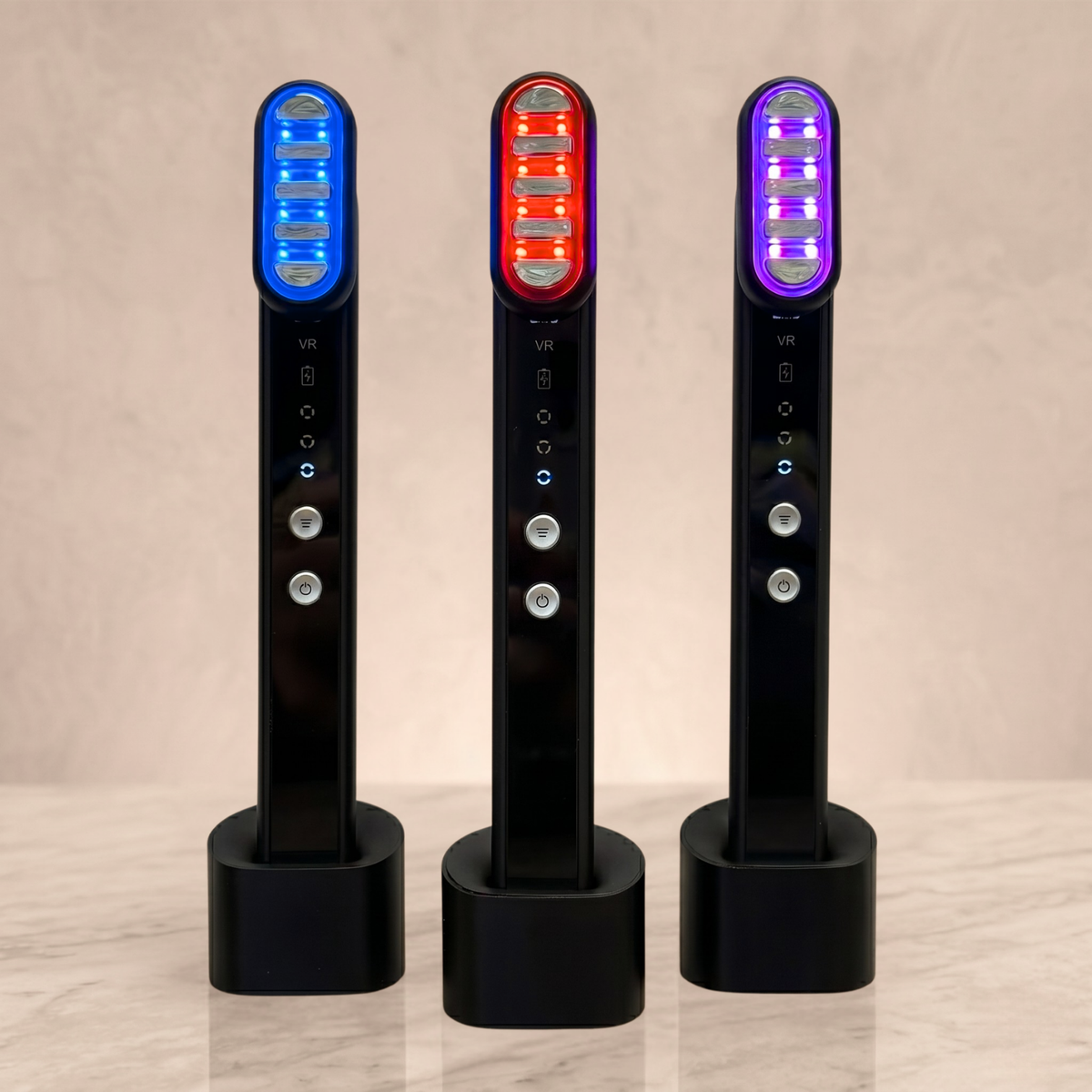 TheraSculpt devices in their charging stands in blue, red and purple light