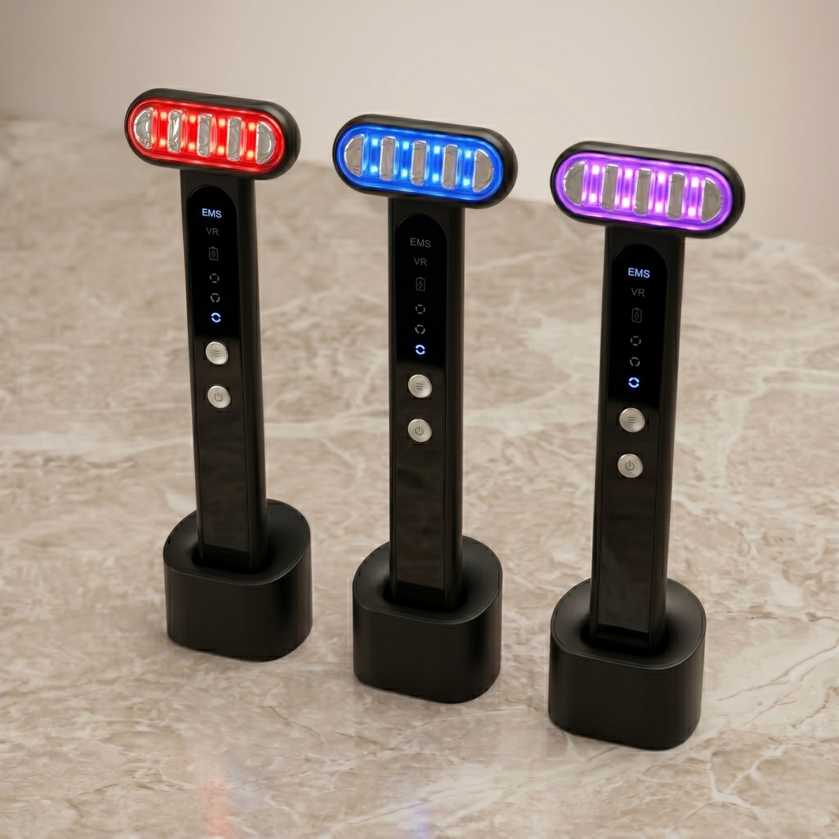 Three TheraSculpt devices on charging stands with red, blue and purple heads lit