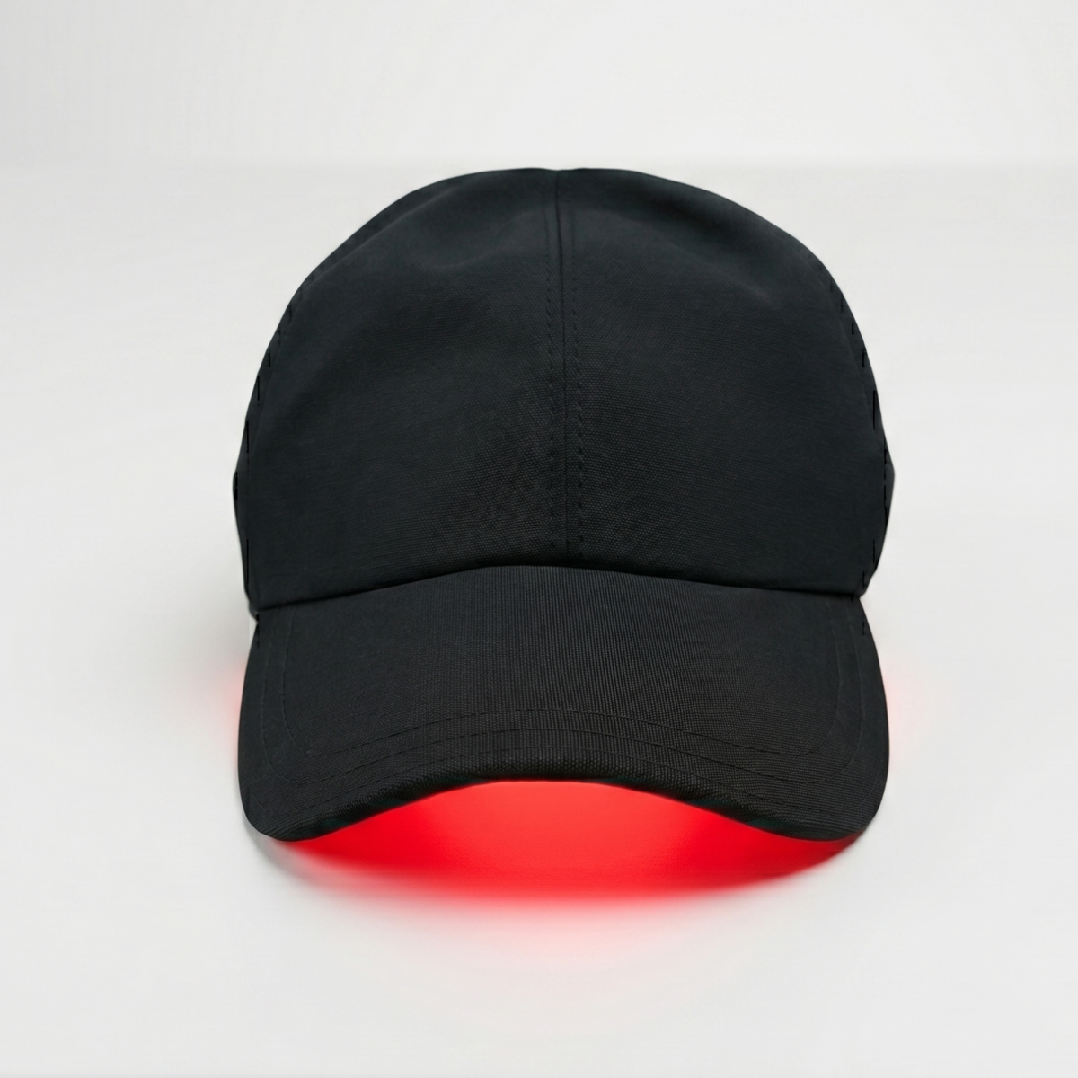 TheraCap red light hair hat with red light glowing under the brim