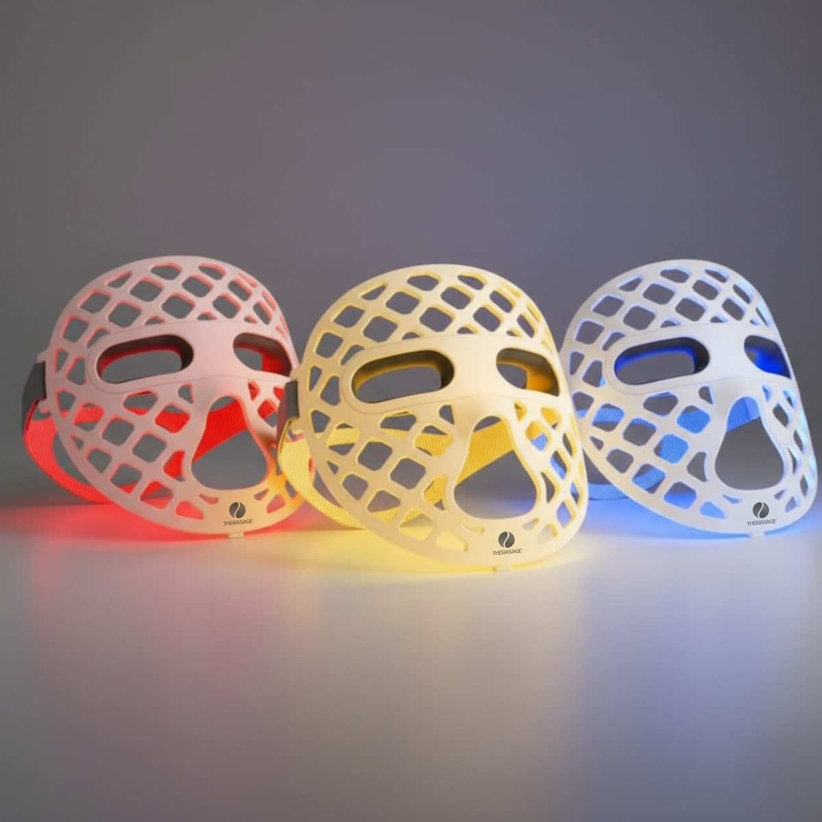 Three TheraGlow Mask2Go+ masks showing red, yellow and blue light