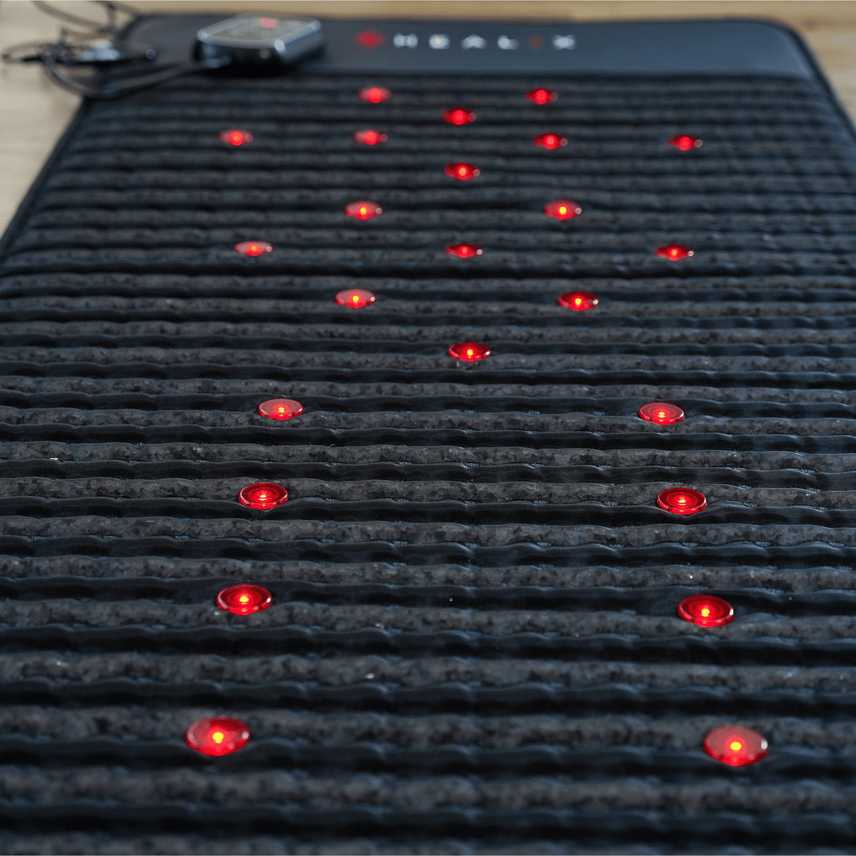 HEALiX Revive PEMF Mat surface close-up showing red photon lights