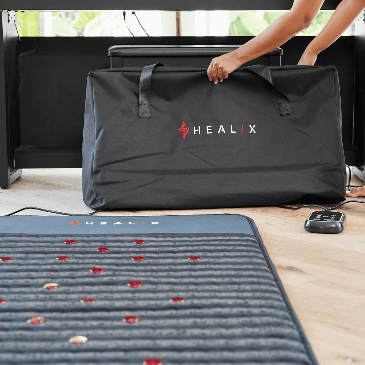 HEALiX Revive PEMF Mat with its carry bag being picked up