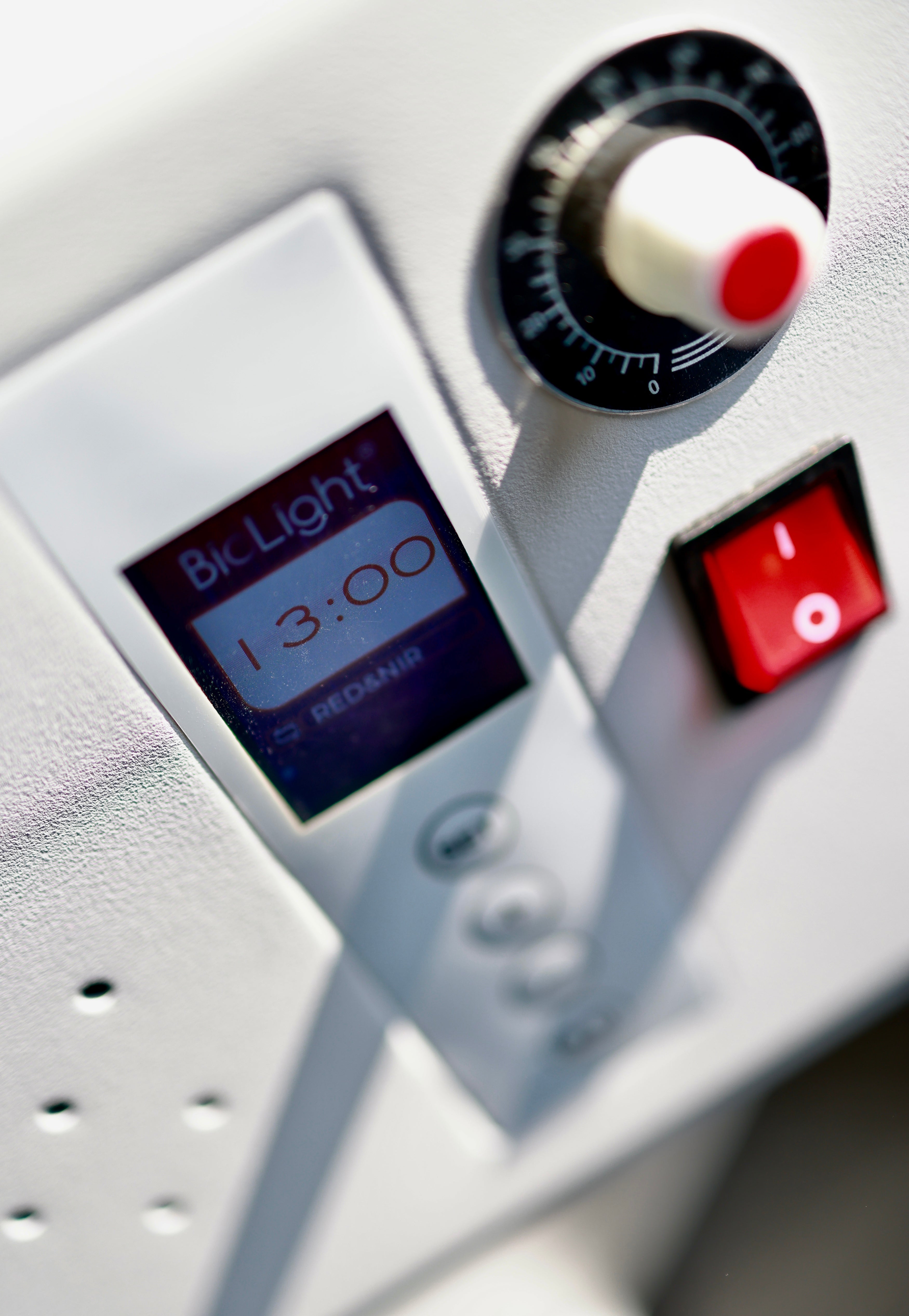 Close-up of the BioLight Adapt System control panel with timer display, dial, and power switch