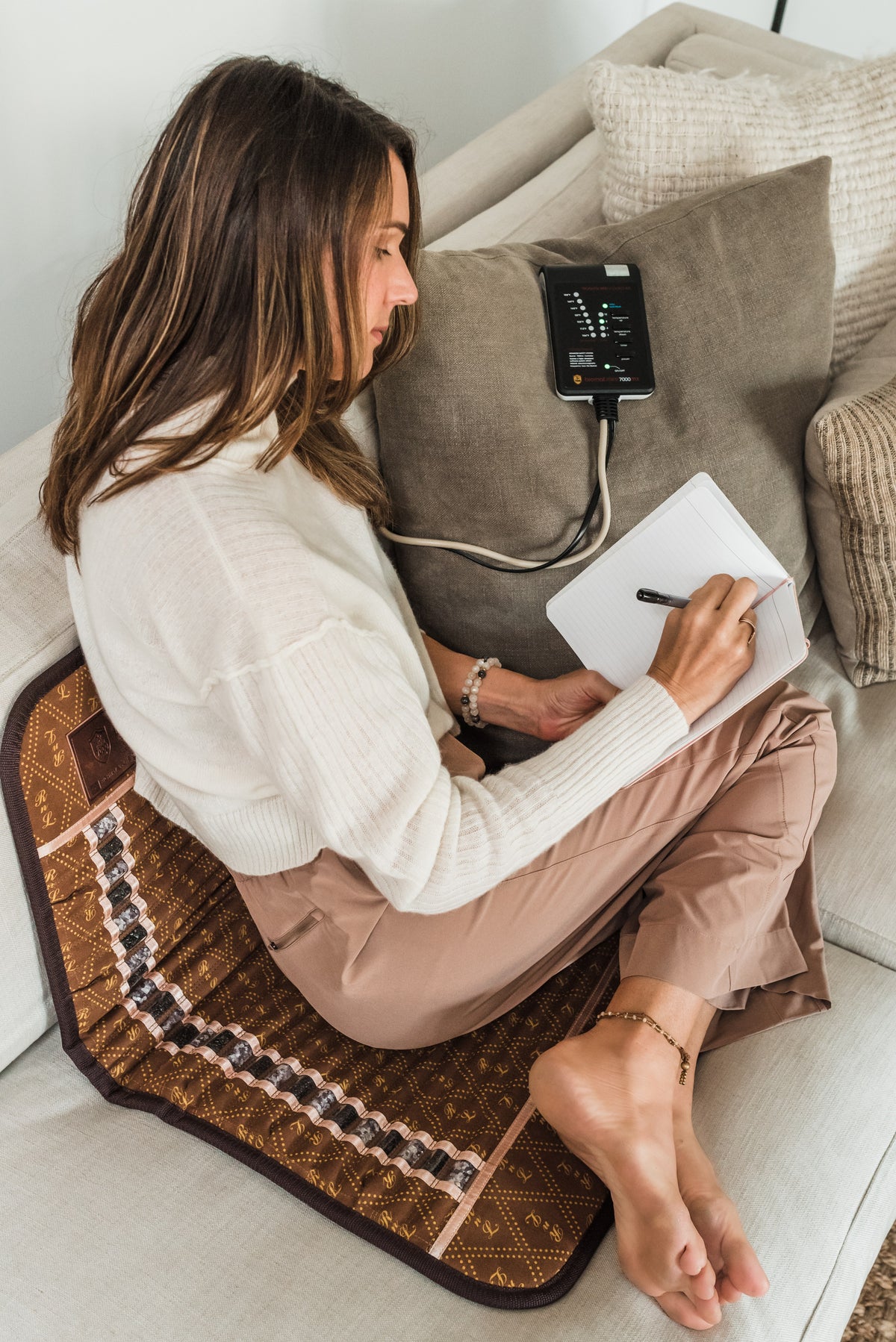 Journaling on the sofa with the BioMat Mini