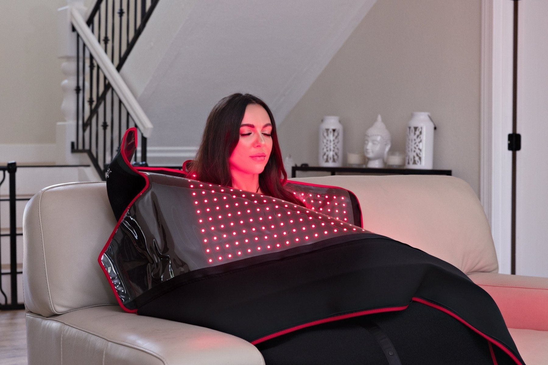 MitoPOD worn seated in a recliner with red LEDs on