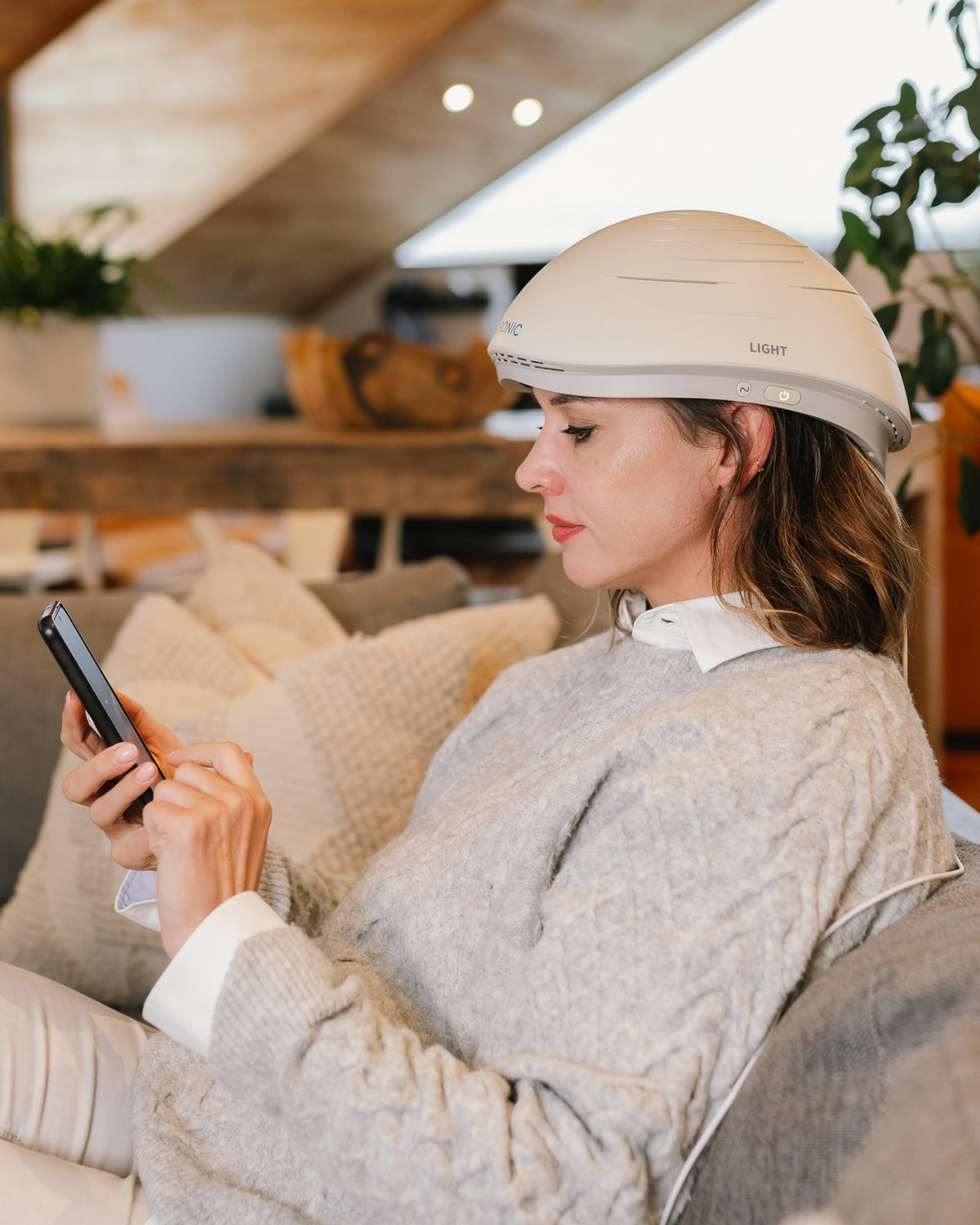 Woman using the Neuronic app while wearing the LIGHT helmet