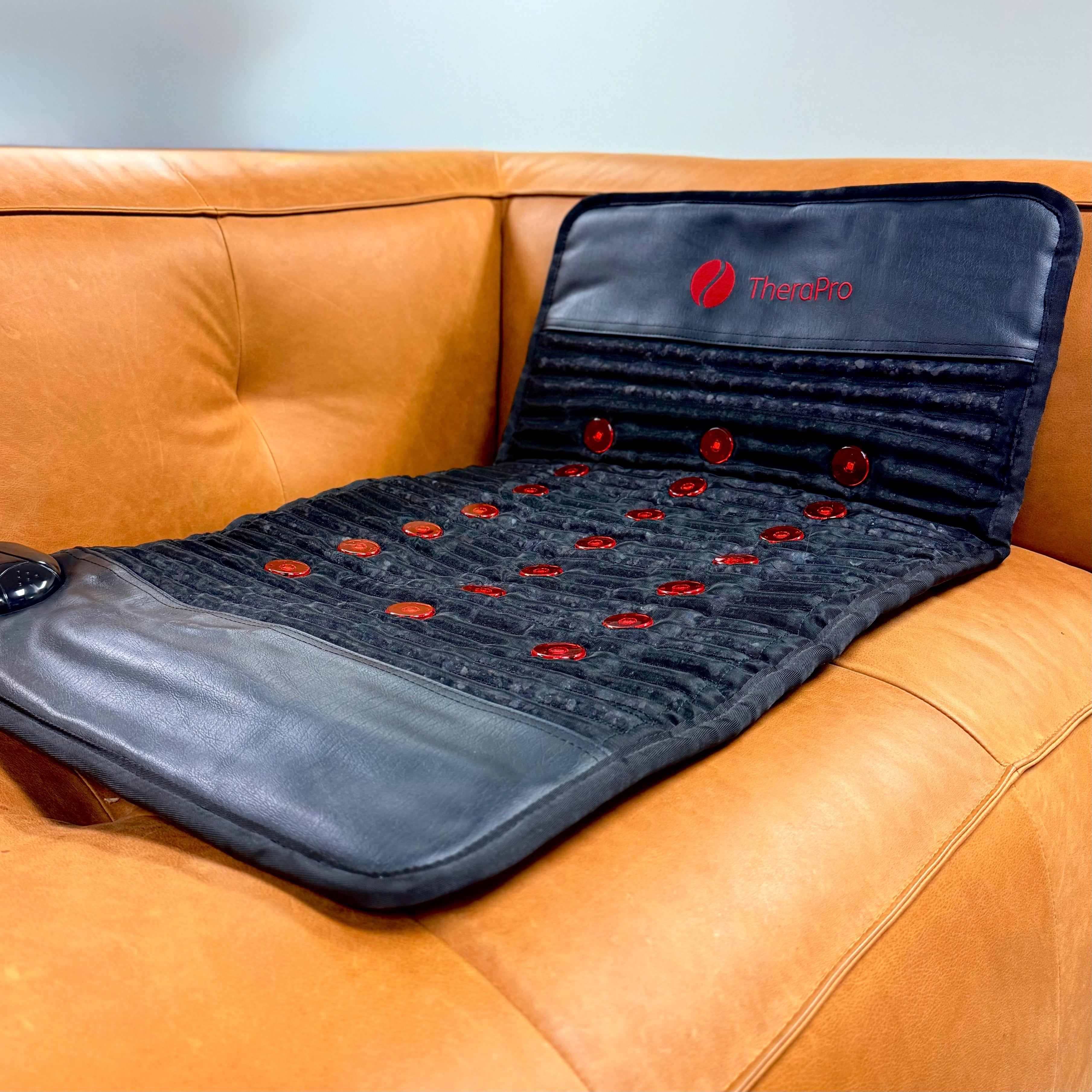 TheraPro Recovery Pad Large draped over a leather couch